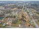 Aerial view of a residential neighborhood with a variety of houses and tree cover at 709 High St, Albemarle, NC 28001
