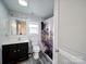 Neat bathroom featuring a modern vanity and toilet beneath a bright window at 709 High St, Albemarle, NC 28001