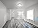 Clean and bright bedroom with plank floors, large window, and easy access to additional rooms at 709 High St, Albemarle, NC 28001