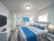Clean bedroom with a bed, tv, plank flooring, and bright natural lighting at 709 High St, Albemarle, NC 28001