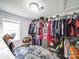 Large walk-in closet with clothing racks, gray rug, a window, and personal items at 709 High St, Albemarle, NC 28001