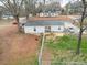 Aerial view of a home with a fenced-in backyard, surrounded by trees and a street at 709 High St, Albemarle, NC 28001
