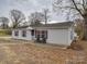 Cozy home featuring light vinyl siding, red shutters, front door and walkway at 709 High St, Albemarle, NC 28001