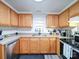 Well-lit kitchen featuring light wood cabinets, stainless steel appliances, and modern fixtures at 709 High St, Albemarle, NC 28001