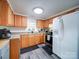 Bright kitchen featuring light wood cabinets, stainless steel appliances, and modern fixtures at 709 High St, Albemarle, NC 28001