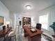 Bright and functional office space with wood desk, plank floors, and neutral walls at 709 High St, Albemarle, NC 28001