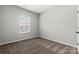 This bedroom features neutral carpet and walls with a window to let light in at 7113 Brookview Ln, Sherrills Ford, NC 28673