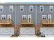 Townhome exterior with gray siding, brick accents, garage, and small wooden balconies at 7113 Brookview Ln, Sherrills Ford, NC 28673