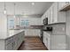 Bright kitchen with modern stainless steel appliances, an island, white cabinets, and hardwood floors at 7113 Brookview Ln, Sherrills Ford, NC 28673