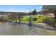 Waterfront view with grassy lawn, rock features, and a fire pit provides a serene outdoor setting at 7113 Brookview Ln, Sherrills Ford, NC 28673