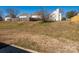 Large backyard with grass featuring a wood fence and mature trees to allow for privacy at 7220 Hidden Creek Dr, Charlotte, NC 28214