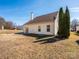 Spacious backyard featuring a well-maintained lawn and mature trees, perfect for outdoor activities and relaxation at 7220 Hidden Creek Dr, Charlotte, NC 28214