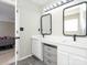 Bright bathroom with dual sinks, modern fixtures, and wood-look flooring at 7220 Hidden Creek Dr, Charlotte, NC 28214