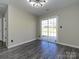Bedroom featuring gray wood floors and sliding glass doors to outside patio at 7220 Hidden Creek Dr, Charlotte, NC 28214