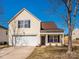 Charming two-story home with attached garage, complemented by a well-maintained lawn and clear blue skies at 7220 Hidden Creek Dr, Charlotte, NC 28214