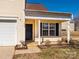 Inviting home exterior with a charming front porch, a manicured garden bed, and a pristine two-car garage at 7220 Hidden Creek Dr, Charlotte, NC 28214