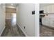 Bright hallway with wood floors leading to an open living space with a modern kitchen, and lots of natural light at 7220 Hidden Creek Dr, Charlotte, NC 28214