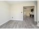 Open living space with new flooring and neutral paint, leading into a naturally lit room with TV at 7220 Hidden Creek Dr, Charlotte, NC 28214