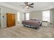 Spacious main bedroom with a tray ceiling, neutral colors, and natural light from the windows at 7220 Hidden Creek Dr, Charlotte, NC 28214