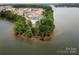 Aerial view of a community nestled on a peninsula, featuring a pool, lake views, and verdant surroundings at 7441 Fighting Creek Rd # 30, Sherrills Ford, NC 28673