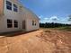 Side angle of house showing backyard and rough graded property highlighting the potential yard space at 7441 Fighting Creek Rd # 30, Sherrills Ford, NC 28673