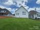 Large, sloped backyard with lush green grass, providing a serene and private outdoor space at 7441 Fighting Creek Rd # 30, Sherrills Ford, NC 28673