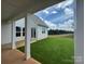 Covered patio overlooking a large, beautifully maintained backyard with mature trees in the distance at 7441 Fighting Creek Rd # 30, Sherrills Ford, NC 28673