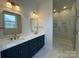 Modern bathroom features a double sink vanity and glass enclosed shower with marble tiling at 7441 Fighting Creek Rd # 30, Sherrills Ford, NC 28673