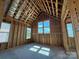 Bedroom with a vaulted ceiling, framed windows, and wood construction, awaiting finishing at 7441 Fighting Creek Rd # 30, Sherrills Ford, NC 28673