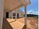 Newly built covered patio with sturdy support columns and view of the surrounding undeveloped land at 7441 Fighting Creek Rd # 30, Sherrills Ford, NC 28673