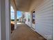 Side view of the home, highlighting the covered porch and view of the neighboring houses at 7441 Fighting Creek Rd # 30, Sherrills Ford, NC 28673