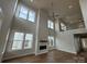 Finished two-story living room with wood flooring, fireplace, and large windows at 7441 Fighting Creek Rd # 30, Sherrills Ford, NC 28673