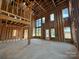 Unfinished living room featuring exposed framing, high ceilings, and natural light at 7441 Fighting Creek Rd # 30, Sherrills Ford, NC 28673
