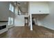 Finished two-story living room with wood flooring and a fireplace below a balcony at 7441 Fighting Creek Rd # 30, Sherrills Ford, NC 28673