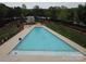 Stunning aerial view of a large community pool with lake views, surrounded by lush landscaping and a charming gazebo at 7441 Fighting Creek Rd # 30, Sherrills Ford, NC 28673