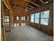 An in-progress room with wood framing and multiple windows, showcasing the structure and natural light potential at 7441 Fighting Creek Rd # 30, Sherrills Ford, NC 28673
