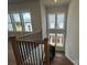 Finished stairway featuring natural light and iron railing at 7441 Fighting Creek Rd # 30, Sherrills Ford, NC 28673