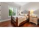 Cozy bedroom features hardwood floors, a decorative iron bed frame, and natural light from the window at 7461 Barrington Ridge Dr # 33, Indian Land, SC 29707