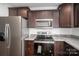 Modern kitchen with stainless steel appliances and dark wood cabinets for a sleek look at 801 Long Shoals Rd, Lincolnton, NC 28092