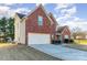 Two-story brick house with an attached garage and a long driveway on a sunny day at 8013 Pelorus Ln, Charlotte, NC 28269