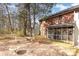A beautiful brick house with a cozy screened porch and outdoor seating, nestled in a serene, wooded backyard at 1035 Nw Wexford Pl # D3, Concord, NC 28027
