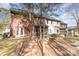 Spacious backyard featuring a red brick exterior, screened porches, a stone bench, and mature trees at 1035 Nw Wexford Pl # D3, Concord, NC 28027