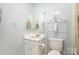 Bright bathroom featuring a pedestal sink, decorative mirror, and stylish decor at 1035 Nw Wexford Pl # D3, Concord, NC 28027