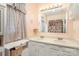 Bright bathroom with double sink vanity, framed mirror, and shower with decorative curtain at 1035 Nw Wexford Pl # D3, Concord, NC 28027