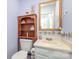 Charming powder room with decorative wallpaper, wood shelving, and a framed mirror at 1035 Nw Wexford Pl # D3, Concord, NC 28027