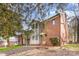 Brick and siding townhome with mature landscaping and mulched front yard at 1035 Nw Wexford Pl # D3, Concord, NC 28027