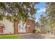 Townhome exterior with brick and siding, surrounded by mature trees and landscaping at 1035 Nw Wexford Pl # D3, Concord, NC 28027