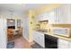 Bright kitchen features white cabinets, appliances, and adjacent breakfast nook at 1035 Nw Wexford Pl # D3, Concord, NC 28027