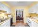 Bright kitchen features laminate counters, white cabinets, wood floors, and opens to the living room at 1035 Nw Wexford Pl # D3, Concord, NC 28027