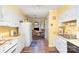 Bright eat-in kitchen features white cabinets, laminate counters, wood floors, and stainless steel appliances at 1035 Nw Wexford Pl # D3, Concord, NC 28027